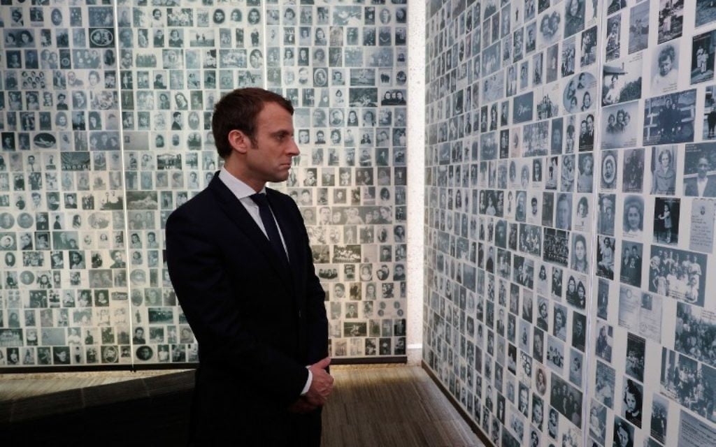 French presidential election candidate for the En Marche! movement Emmanuel Macron looks at some of the 2,500 photographs of young Jews deported from France during the WWII Nazi occupation, during a visit to the Shoah Memorial on April 30, 2017 in Paris. (AFP/Pool/Philippe Wojazer) French presidential election candidate for the En Marche! movement Emmanuel Macron looks at some of the 2,500 photographs of young Jews deported from France during the WWII Nazi occupation, during a visit to the Shoah Memorial on April 30, 2017 in Paris. (AFP/Pool/Philippe Wojazer)