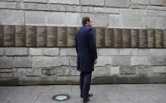 French presidential election candidate for the En-Marche movement, Emmanuel Macron stands at the Wall of the Rigtheous (Le Mur des Justes) during a visit to the Shoah Memorial on April 30, 2017 in Paris. (AFP PHOTO / POOL / PHILIPPE WOJAZER)