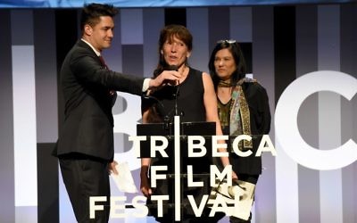 Bobbi Jene Smith (C) accpets the Best Documentary Cinematography Award on behalf of Elvira Lind from Jurors David Wilson (L) and Barbara Kopple (R) during Awards Night during the 2017 Tribeca Film Festival at BMCC Tribeca PAC on April 27, 2017 in New York City. (Nicholas Hunt/Getty Images for Tribeca Film Festival/AFP)