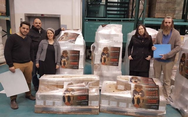 Leaders from the Just Beyond our Border campaign stand next to boxes of aid that were shipped off to Syria. (Courtesy) Leaders from the Just Beyond our Border campaign stand next to boxes of aid that were shipped off to Syria. (Courtesy)