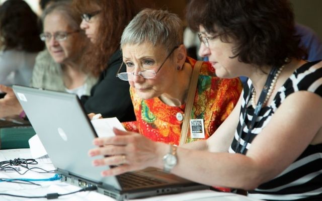 USHMM researchers show documents they found in the ITS archive to requesters during a stop in Chicago on the museum's 20th anniversary tour in the summer of 2013. (Courtesy USHMM)