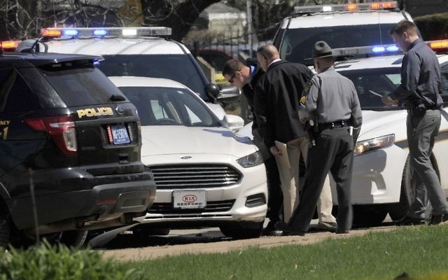 Pennsylvania State Police look over a car as they investigate the scene where Steve Stephens, the suspect in the random killing of a Cleveland retiree posted on Facebook, was found shot dead Tuesday, April 18, 2017, in Erie. Pa. (Greg Wohlford/Erie Times-News via AP)