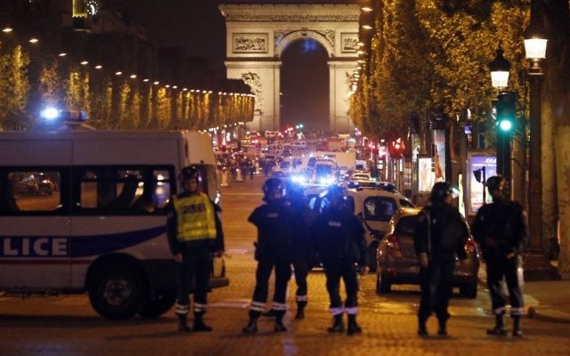 Police seal off the Champs-Elysees avenue in Paris, France, after a fatal shooting, April 20, 2017. (AP/Kamil Zihnioglu) Police seal off the Champs-Elysees avenue in Paris, France, after a fatal shooting, April 20, 2017. (AP/Kamil Zihnioglu)