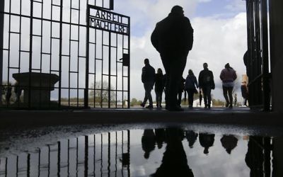 People enter the Sachsenhausen Nazi death camp through the gate with the inscription 'Arbeit macht frei' (work sets you free) for commemorations for the 72nd anniversary of the liberation of the camp in Oranienburg, about 35 kilometer north of Berlin, April 23, 2017. (AP/Markus Schreiber)