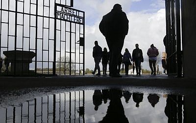 People enter the Sachsenhausen Nazi death camp through the gate with the inscription 'Arbeit macht frei' (work sets you free) for commemorations for the 72nd anniversary of the liberation of the camp in Oranienburg, about 35 kilometer north of Berlin, April 23, 2017. (AP/Markus Schreiber)