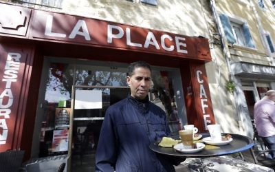Mohamed Zhani, stands outside his cafe restaurant "La Place" in Beaucaire, southern France, on Tuesday April 4, 2017. (AP Photo/Claude Paris)