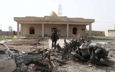 A soldier inspects the damage at a mosque after a car bomb attack in Tikrit in 2015 (AP Photo/Khalid Mohammed)