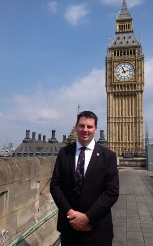 Andrew Percy stands next to Big Ben in London. (Courtesy)