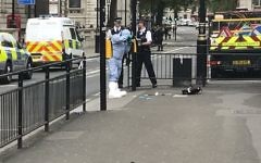 Police photograph items on the pavement in Whitehall, London, Thursday April 27, 2017, after a man was arrested by police. London police say they have arrested a man for possession of offensive weapons near Britain's Houses of Parliament. (Ross Kempsell‏ via AP)
