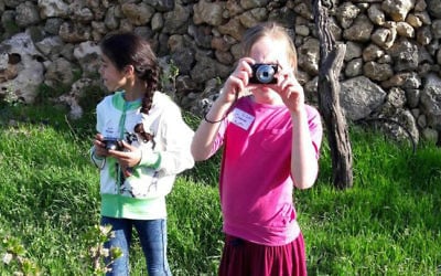 Young Israeli and Palestinian girls take photos together in Ard, as part of the Roots coexistence initiative. (Brett Kline/Times of Israel)