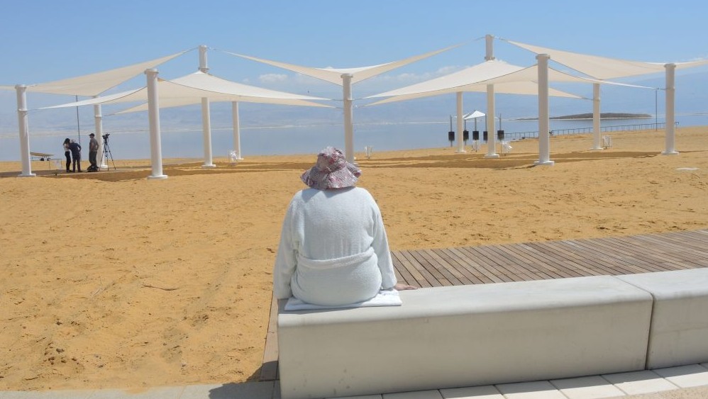 A woman enjoys the new promenade in Ein Boqek on April 3, 2017. (Melanie Lidman/Times of Israel)