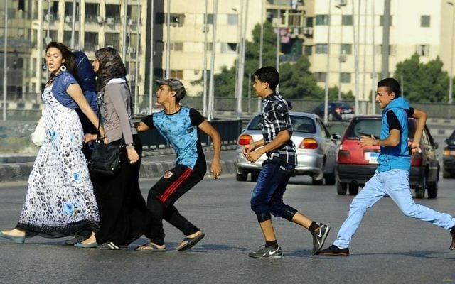 In this Aug. 20, 2012 file photo, an Egyptian youth, trailed by his friends, gropes a woman crossing the street with her friends in Cairo, Egypt. (AP/Ahmed Abd El Latif, El Shorouk Newspaper) In this Aug. 20, 2012 file photo, an Egyptian youth, trailed by his friends, gropes a woman crossing the street with her friends in Cairo, Egypt. (AP/Ahmed Abd El Latif, El Shorouk Newspaper)