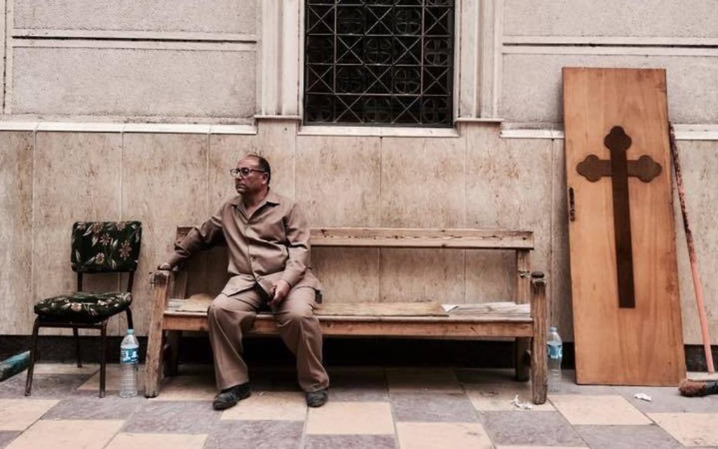 A man sits on a bench outside a church after a bomb attack in the Nile Delta town of Tanta, Egypt, Sunday, April 9, 2017. (AP Photo/Nariman El-Mofty)