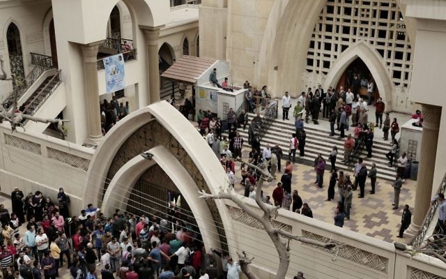 People gather outside the St. George's Church after a deadly suicide bombing, in the Nile Delta town of Tanta, Egypt, Sunday, April 9, 2017. (AP Photo/Nariman El-Mofty) People gather outside the St. George's Church after a deadly suicide bombing, in the Nile Delta town of Tanta, Egypt, Sunday, April 9, 2017. (AP Photo/Nariman El-Mofty)