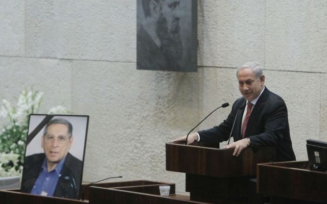 Prime Minister Benjamin Netanyahu speaks next to a picture of assassinated MK Rehavam Ze'evi at the Knesset on October 16, 2012. (Miriam Alster/Flash 90)