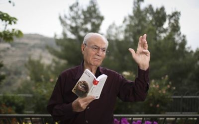 Portrait of Israeli author, Eli Amir, with his recent book, in his home in Jerusalem, on May 5, 2014. Eli Amir's book, 'The Dove Flyer' (or, 'Farewell Baghdad'), about a Zionist family living in Baghdad, was adapted to a movie that was recently released to the big screen. (Hadas Parush/Flash 90.)