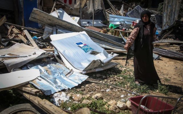 Illustrative: A Bedouin woman inspects the damage of their home after an Israeli bulldozer had demolished the house of the Dahouk family in the Bedouin community of Khan Al Ahmar, in the West Bank east of Jerusalem, on April 7, 2016. (Flash90) Illustrative: A Bedouin woman inspects the damage of their home after an Israeli bulldozer had demolished the house of the Dahouk family in the Bedouin community of Khan Al Ahmar, in the West Bank east of Jerusalem, on April 7, 2016. (Flash90)