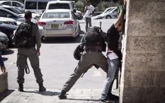 Illustrative: A Border Police officer frisks a Palestinian man in front of Damascus Gate in Jerusalem's Old City on September 20, 2016. (Sebi Berens/Flash90)