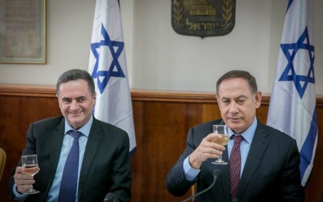 Yisrael Katz, left and prime minister Benjamin Netanyahu raise a toast for the Jewish holiday of Passover during the weekly cabinet meeting at the prime minister office in Jerusalem, on April 9, 2017. (Ohad Zweigenberg/POOL) Yisrael Katz, left and prime minister Benjamin Netanyahu raise a toast for the Jewish holiday of Passover during the weekly cabinet meeting at the prime minister office in Jerusalem, on April 9, 2017. (Ohad Zweigenberg/POOL)