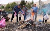Religious Jews in the settlement of Migdal Oz burn leavened products ahead of the Passover holiday on April 10, 2017. (Gershon Elinson/Flash90)