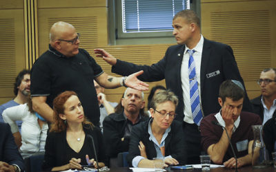 Bereaved father Ilan Sagi (L) reacts at the State Control committee meeting in the Israeli parliament during a discussion about the Operation Protective Edge report, on April 19, 2017. Lea Goldin, the mother of Lt. Hadar Goldin, whose body is being held by Hamas is pictured in the center (Hadas Parush/Flash90)