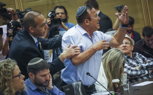 A man reacts at the State Control committee meeting in the Israeli parliament during a discussion about the Operation Protective Edge report, on April 19, 2017. (Hadas Parush/Flash90) A man reacts at the State Control committee meeting in the Israeli parliament during a discussion about the Operation Protective Edge report, on April 19, 2017. (Hadas Parush/Flash90)