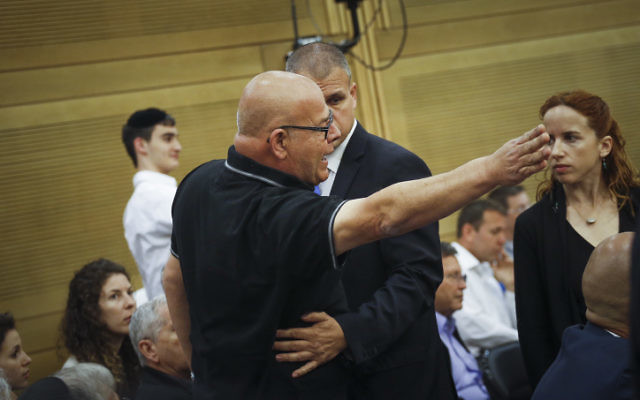The father of a fallen soldier reacts at the State Control committee meeting in the Israeli parliament during a discussion about the Operation Protective Edge report, on April 19, 2017 (Hadas Parush/Flash90) The father of a fallen soldier reacts at the State Control committee meeting in the Israeli parliament during a discussion about the Operation Protective Edge report, on April 19, 2017 (Hadas Parush/Flash90)