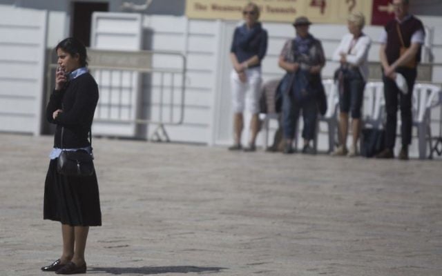 An Orthodox woman stands still at the Western Wall in Jerusalem, as a two-minute siren is sounded across Israel to mark Holocaust Remembrance Day on April 24, 2017. (Lior Mizrahi/Flash90) An Orthodox woman stands still at the Western Wall in Jerusalem, as a two-minute siren is sounded across Israel to mark Holocaust Remembrance Day on April 24, 2017. (Lior Mizrahi/Flash90)