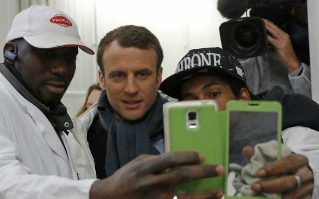 French presidential candidate Emmanuel Macron, center, poses for a selfie with employees as he visits the meat pavilion at the Rungis wholesale food market south of Paris, April 18, 2017. (Philippe Wojazer; Pool via AP)