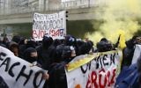 Protesters against far-right National Front leader and presidential candidate Marine Le Pen hold a banner reading 'fascist' during a protest march from suburban Aubervilliers to Paris, Sunday, April 16, 2017. (AP/Francois Mori)