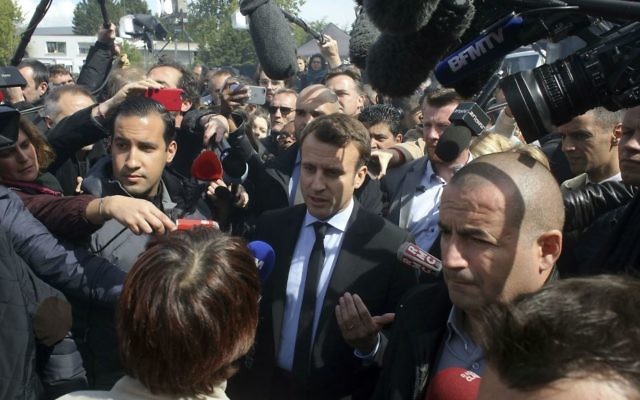 French centrist presidential election candidate Emmanuel Macron, center, talks to workers at the Whirlpool home appliance factory, Wednesday April 26, 2017 in Amiens, northern France. (AP Photo/Thibault Camus)