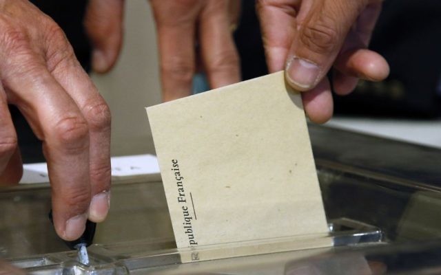 A man casts his vote for the first-round presidential election at a polling in Tulle central France, Sunday, April 23, 2017. (AP Photo/Bob Edme)