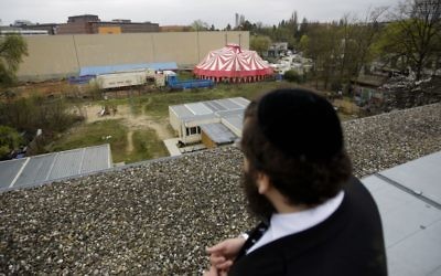 Rabbi Yehuda Teichtal looks down from a roof top to the area with a temporary circus tent, where he is planning to build a Jewish campus in Berlin, Germany, April 3, 2017. (AP Photo/Markus Schreiber)