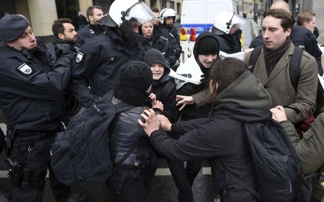 Participants of a demonstration against a two-day party convention of the nationalist AfD (Alternative for Germany) clash with some of their supporters in Cologne, Germany, Saturday, April 22, 2017. (Henning Kaiser/dpa via AP) Participants of a demonstration against a two-day party convention of the nationalist AfD (Alternative for Germany) clash with some of their supporters in Cologne, Germany, Saturday, April 22, 2017. (Henning Kaiser/dpa via AP)