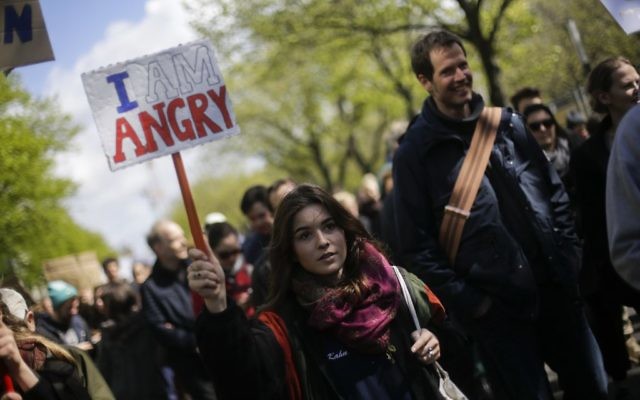 A woman with a poster attends with thousands of demonstrators the March for Science in Berlin, Saturday, April 22, 2017. Thousands of people are expected to attend March for Science events around the world to promote the understanding of science and defend it from various attacks, including US government budget cuts. (AP Photo/Markus Schreiber)