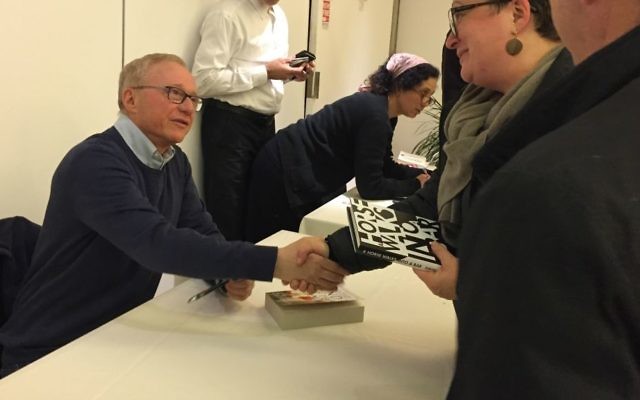 Author David Grossman signs copies of 'A Horse Walked into a Bar' at a April 2, 2017, Times of Israel event in Jerusalem. (Amanda Borschel-Dan/Times of Israel)