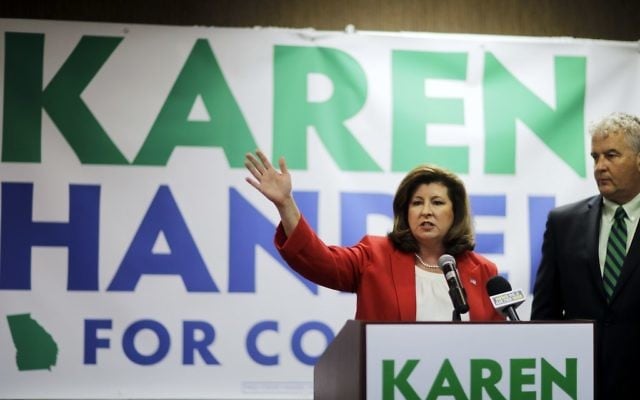 Republican candidate for Georgia's 6th Congressional seat Karen Handel updates supporters with her husband Steve on early results at an election night watch party in Roswell, Georgia, April 18, 2017. (AP Photo/David Goldman)