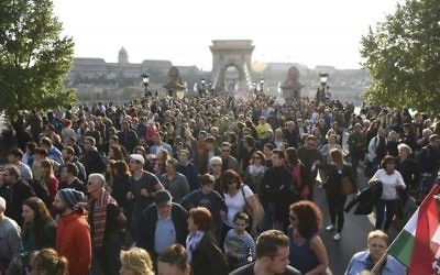 Backdropped by the Chain Bridge and the Royal Palace in the Castle of Buda, demonstrators hold a banner reading "Why are you afraid of education?" as they protest against the efforts to close Central European University, as part of Prime Minister Viktor Orban’s plan to transform Hungary into an “illiberal state” in Budapest, Hungary, Sunday, Apr. 9, 2017.  (Zoltan Balogh/MTI via AP)