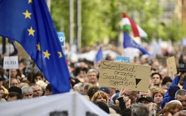 Demonstrators hold a placard reading "Free country, free university!" as they protest against the efforts to close Central European University, as part of Prime Minister Viktor Orban’s plan to transform Hungary into an “illiberal state” in Budapest, Hungary, Sunday, Apr. 9, 2017. (Janos Marjai/MTI via AP)