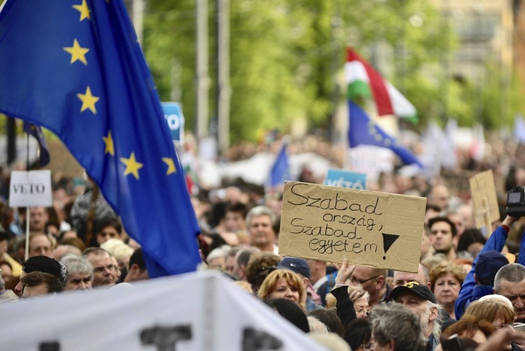 Demonstrators hold a placard reading "Free country, free university!" as they protest against the efforts to close Central European University, as part of Prime Minister Viktor Orban’s plan to transform Hungary into an “illiberal state” in Budapest, Hungary, Sunday, Apr. 9, 2017. (Janos Marjai/MTI via AP) Demonstrators hold a placard reading 'Free country, free university!' as they protest against the efforts to close Central European University, as part of Prime Minister Viktor Orban’s plan to transform Hungary into an 'illiberal state' in Budapest, Hungary, Sunday, April 9, 2017. (Janos Marjai/MTI via AP)