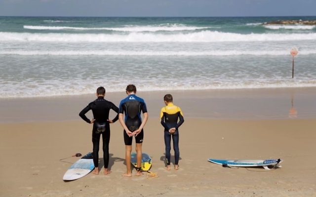 Surfers stand still on the Mediterranean Sea beachfront as a two-minute siren sounds in memory of victims of the Holocaust, in Netanya, Israel, Monday, April 24, 2017. (AP Photo/Ariel Schalit) Surfers stand still on the Mediterranean Sea beachfront as a two-minute siren sounds in memory of victims of the Holocaust, in Netanya, Israel, Monday, April 24, 2017. (AP Photo/Ariel Schalit)