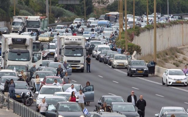 Israelis stand still next to their cars as a siren sounds in memory of victims of the Holocaust, in Tel Aviv, Israel, Monday, April 24, 2017. (AP Photo/Sebastian Scheiner) Israelis stand still next to their cars as a siren sounds in memory of victims of the Holocaust, in Tel Aviv, Israel, Monday, April 24, 2017. (AP Photo/Sebastian Scheiner)