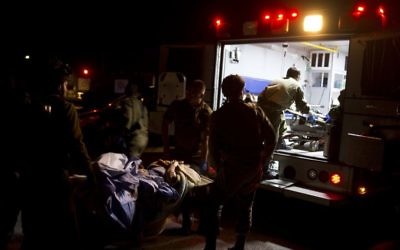 In the Golan Heights, Israeli military medics assist wounded Syrians, April 6, 2017. (AP Photo/Dusan Vranic)