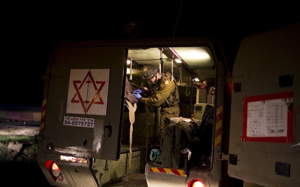 Israeli military medics assist wounded Syrians on April 6, 2017 in a military ambulance. (AP Photo/Dusan Vranic) Israeli military medics assist wounded Syrians on April 6, 2017 in a military ambulance. (AP Photo/Dusan Vranic)