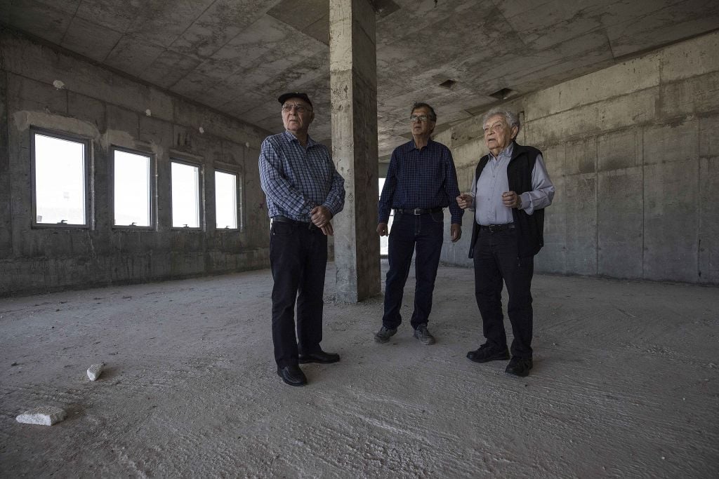 Jewish World War II veterans Chaim Erez, left, Zvi Kan-Tor, center, and Yitzhak Arad stand during an interview with The Associated Press inside the unfinished museum honoring Jewish World War II veterans, in Latrun, Israel, April 18, 2017. (AP Photo/Tsafrir Abayov) Jewish World War II veterans Chaim Erez, left, Zvi Kan-Tor, center, and Yitzhak Arad stand during an interview with The Associated Press inside the unfinished museum honoring Jewish World War II veterans, in Latrun, Israel, April 18, 2017. (AP Photo/Tsafrir Abayov)