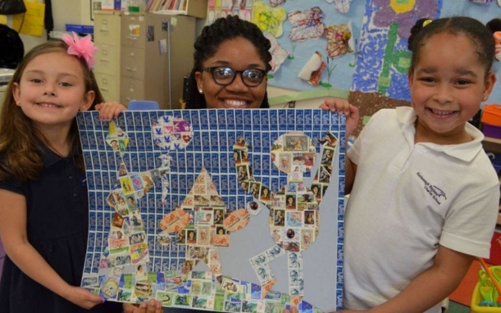 Students at the Foxboro Regional Charter School in Massachusetts pose with a Holocaust-related mural in 2016, created through the school's Holocaust Stamps Project (Courtesy) Students at the Foxboro Regional Charter School in Massachusetts pose with a Holocaust-related mural in 2016, created through the school's Holocaust Stamps Project (Courtesy)