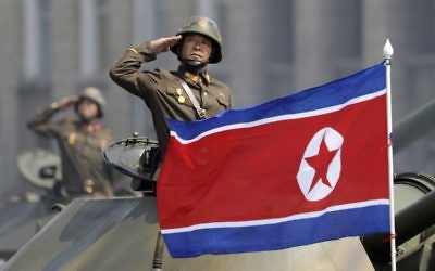 In this Saturday, April 15, 2017, file photo, a North Korean national flag flutters as soldiers in tanks salute to North Korean leader Kim Jong Un during a military parade in Pyongyang, North Korea to celebrate the 105th birth anniversary of Kim Il Sung, the country's late founder and grandfather of the current ruler. (AP Photo/Wong Maye-E, File)