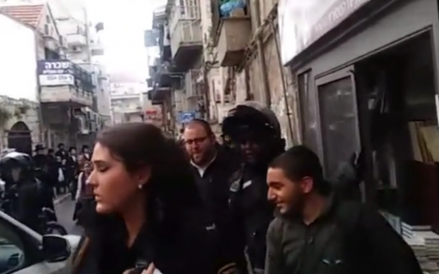 Police rescuing an ultra-Orthodox IDF soldier who was trapped in a bookstore by an angry mob of ultra-Orthodox protesters in Jerusalem on April 2, 2017. (Screen capture: Kikar Hashabat) Police rescuing an ultra-Orthodox IDF soldier who was trapped in a bookstore by an angry mob of ultra-Orthodox protesters in Jerusalem on April 2, 2017. (Screen capture: Kikar Hashabat)