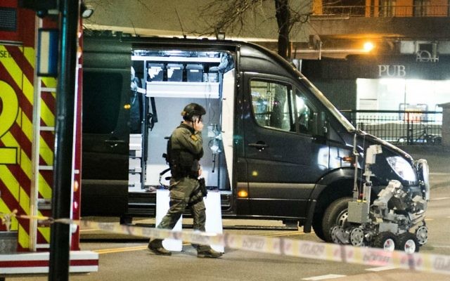 An officer works the scene as police cordon off a large area around a subway station on a busy commercial street Saturday night, April 8, 2017, after finding what they described as a "bomb-like" device, in Oslo, Norway. (Fredrik Varfjell/NTB scanpix via AP)