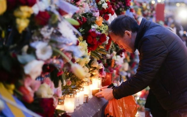 A man lights a candle at a fence near the department store Ahlens, Saturday, April 8, 2017, following Friday's suspected terror attack in central Stockholm, Sweden. (AP Photo/Markus Schreiber) A man lights a candle at a fence near the department store Ahlens, Saturday, April 8, 2017, following Friday's suspected terror attack in central Stockholm, Sweden. (AP Photo/Markus Schreiber)